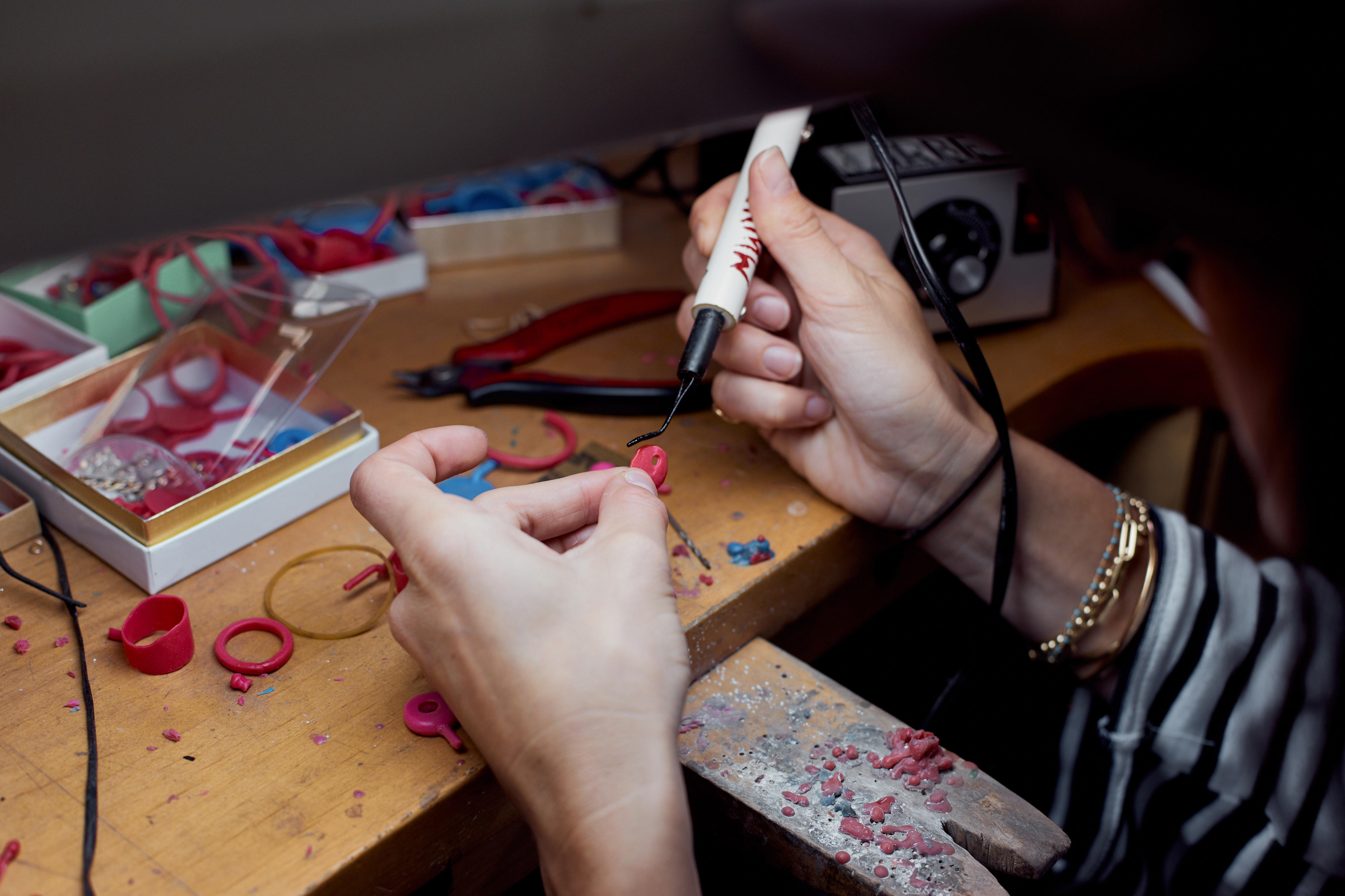 close up of artist hands working at the metal shop